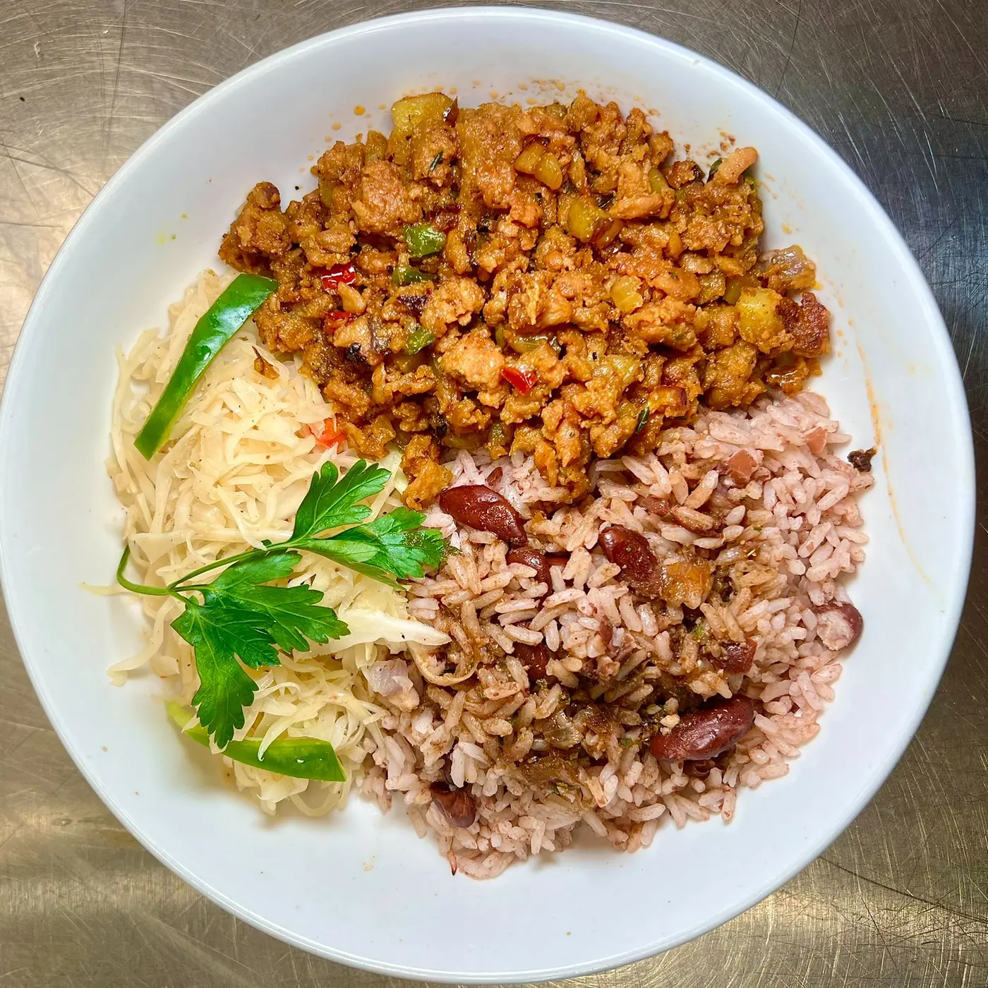 Vegan curry goat with rice and peas and cabbage